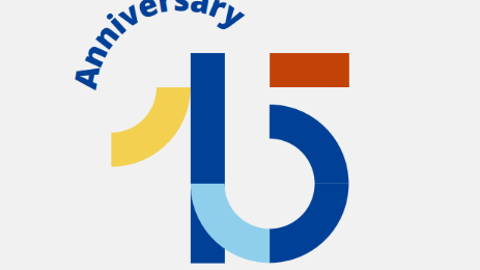 Stylized "15" in blue, yellow, light blue, and brown geometric shapes with the word "Anniversary" curved above, celebrating a 15th anniversary.