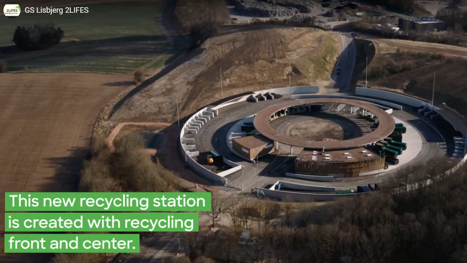 Aerial view of a circular recycling station with white partitions and a central building, surrounded by trees and fields. Text overlay reads: "This new recycling station is created with recycling front and center.