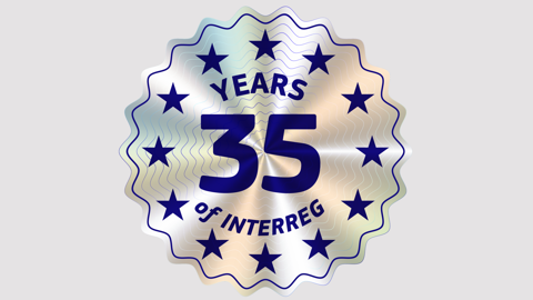 Holographic badge with the text "35 YEARS OF INTERREG" in bold blue letters, surrounded by blue stars on a shiny silver background.