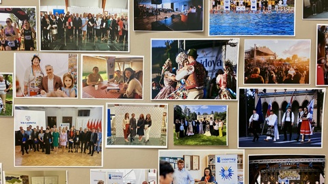 A collage of various photographs showing people at cultural events, ceremonies, group gatherings, traditional dance performances, swimming, and children in classrooms, all displayed on a beige wall.