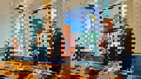 A digital image heavily distorted by horizontal glitch bands in blue, purple, red, yellow, and green, obscuring any recognizable objects or details.