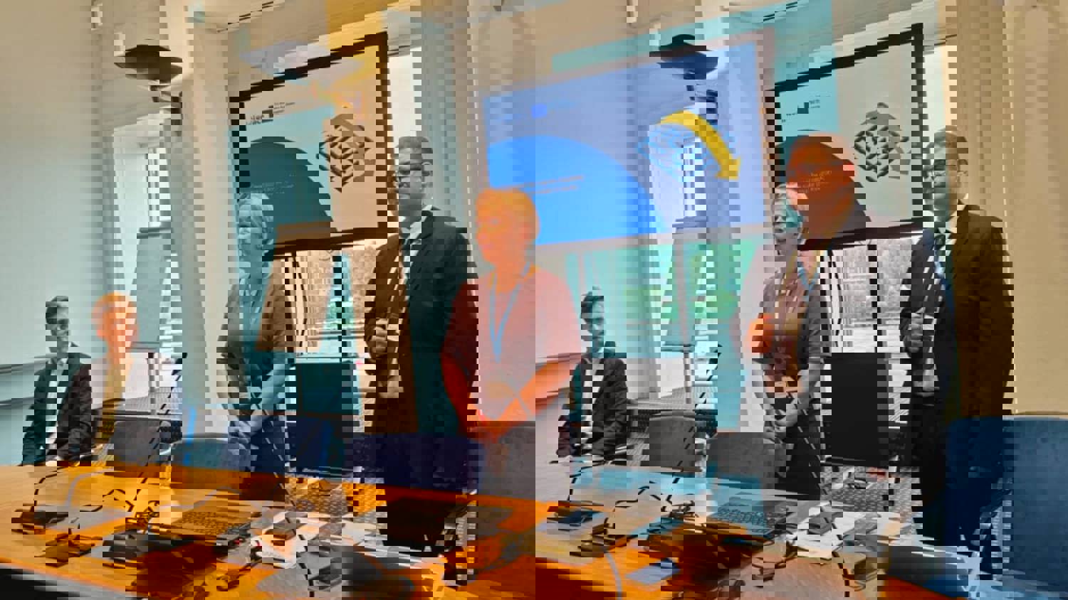 A digital image heavily distorted by horizontal glitch bands in blue, purple, red, yellow, and green, obscuring any recognizable objects or details.
