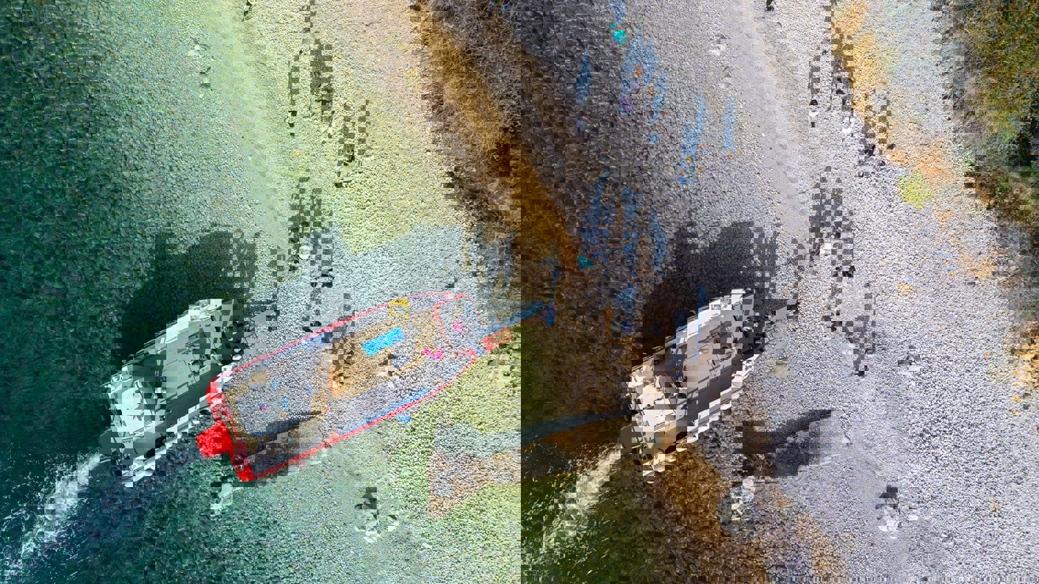 The image appears distorted and corrupted with horizontal bands of bright colors, including yellow, cyan, blue, red, and magenta, obscuring any identifiable content.