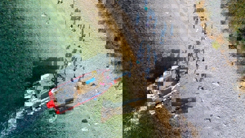 The image appears distorted and corrupted with horizontal bands of bright colors, including yellow, cyan, blue, red, and magenta, obscuring any identifiable content.