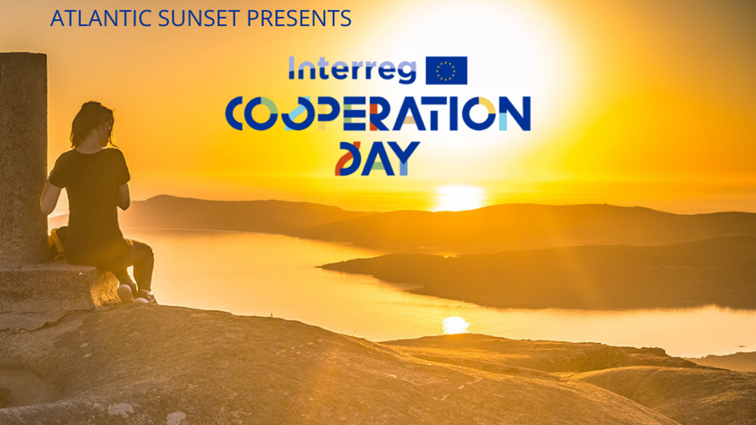 A person sits on a rock overlooking a scenic sunset above a coastline. Text reads "ATLANTIC SUNSET PRESENTS Interreg COOPERATION DAY" with the EU flag logo.