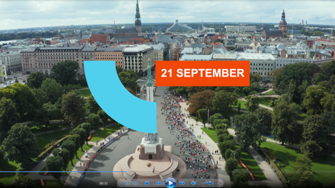 Aerial view of a city square with a crowd gathering around a monument and trees, with "21 September" in bold white letters on an orange rectangle and a large blue arc overlaying the image.