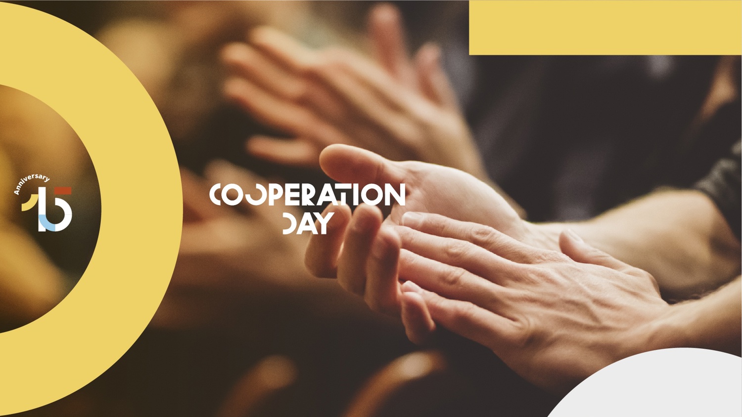 Close-up of hands clapping in an audience, with the words "Cooperation Day" and a "15th anniversary" logo on a yellow and white abstract background.